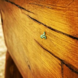 High angle view of small toy on wooden plank