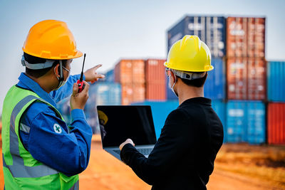 Midsection of man working with mobile phone