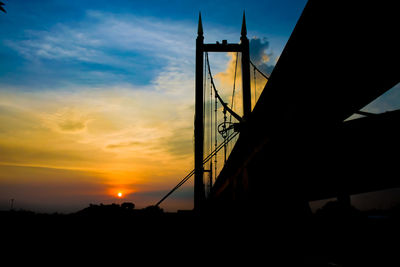 Low angle view of silhouette bridge against sky during sunset