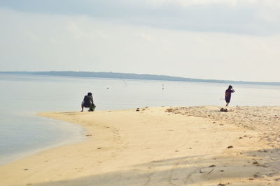 Woman on beach against sky