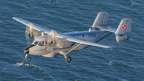 High angle view of airplane flying over sea