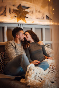 Young couple sitting at home