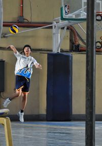 Young man playing basketball at court