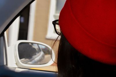 Close-up of woman wearing hat in car