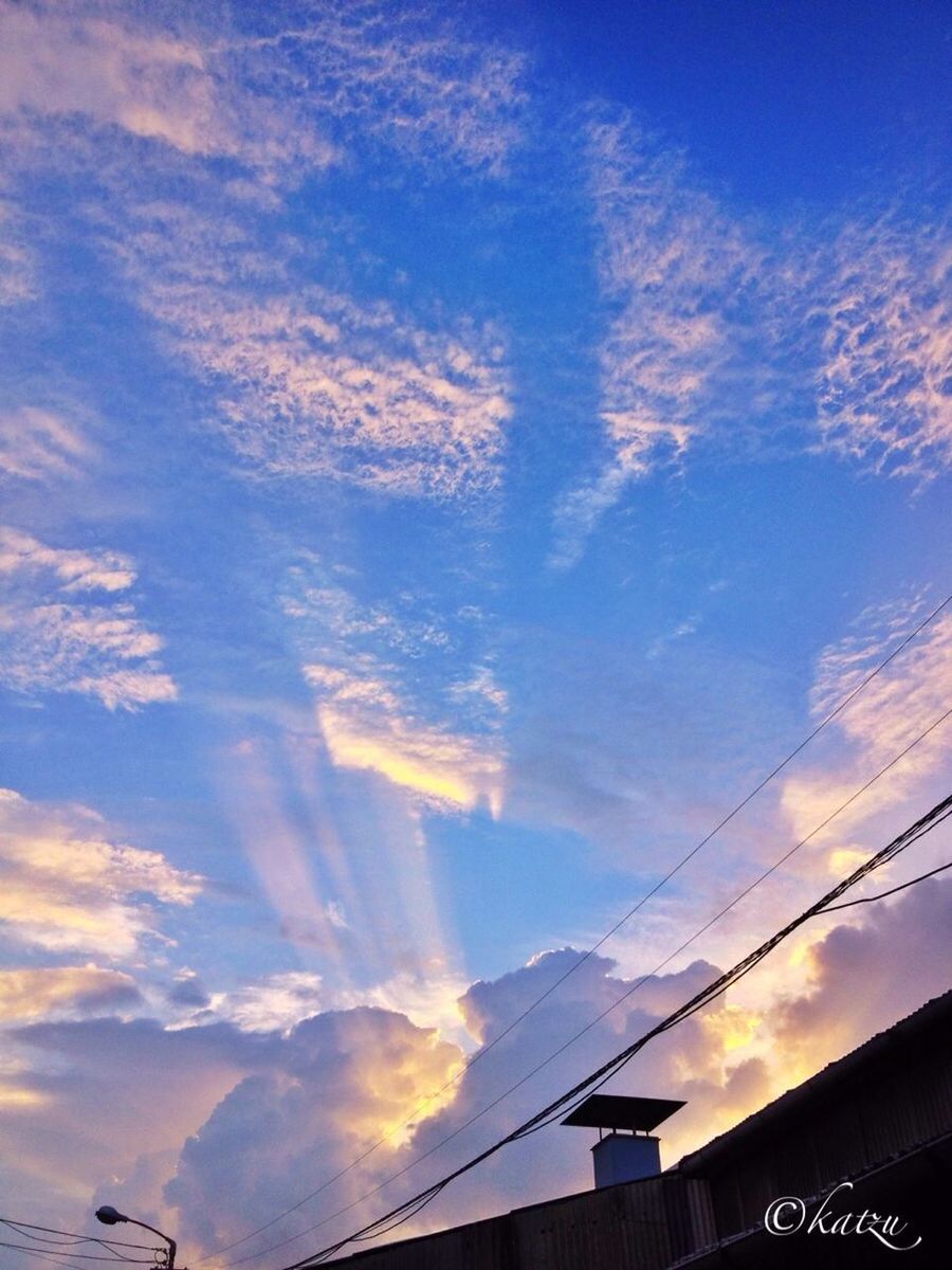 sky, built structure, sunset, architecture, building exterior, low angle view, cloud - sky, power line, silhouette, connection, cloud, cable, orange color, high section, outdoors, no people, electricity pylon, blue, house, nature