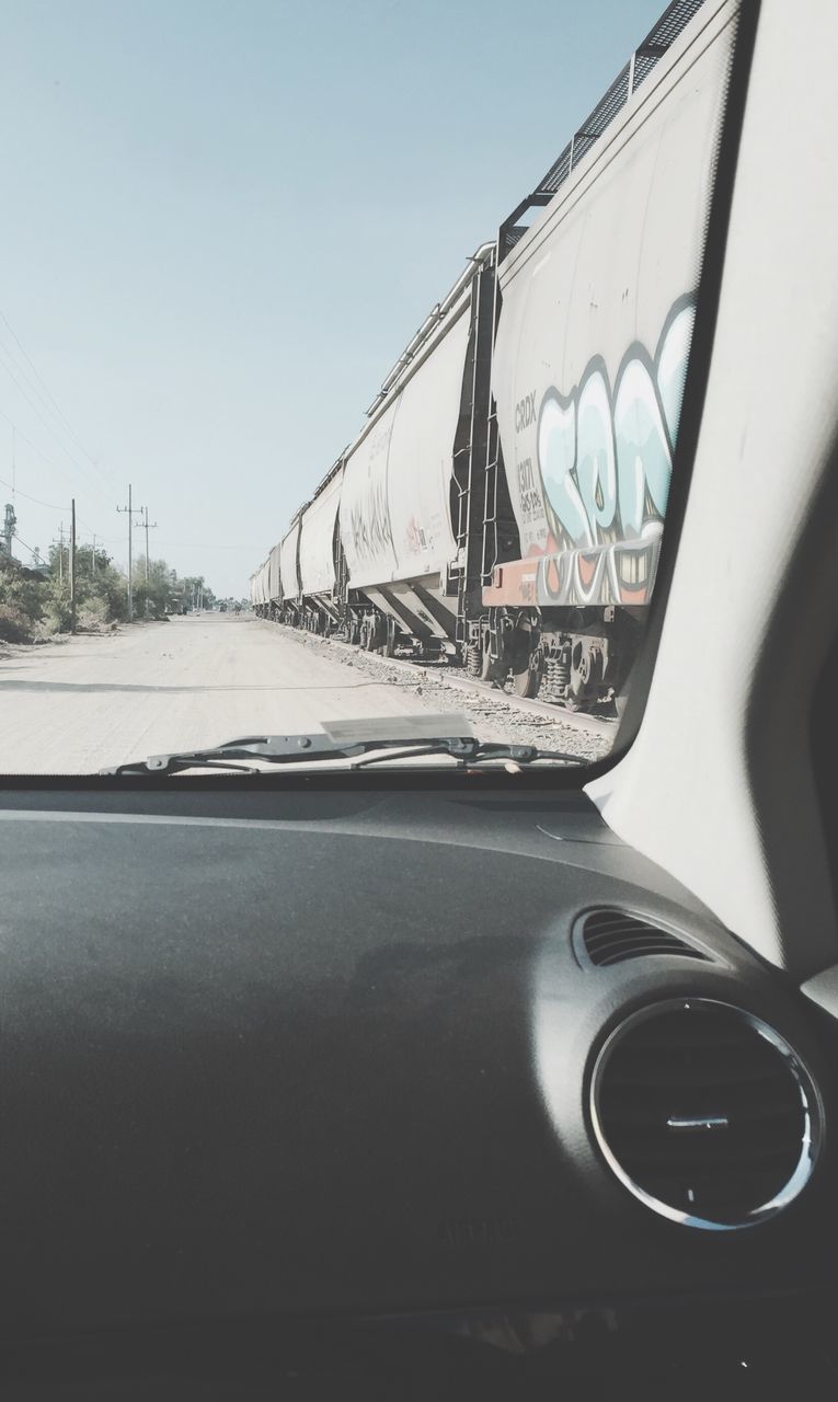 transportation, mode of transport, land vehicle, clear sky, car, travel, sky, cropped, built structure, part of, architecture, day, road, no people, outdoors, vehicle interior, close-up, connection, metal, sunlight