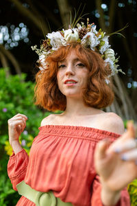 Portrait of beautiful woman with red flower