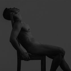 Naked man against gray background
