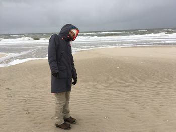 Full length of woman standing at beach