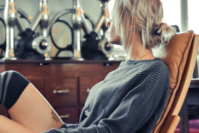 Midsection of woman sitting at home