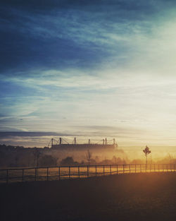 Scenic view of a soccer stadium  against sky during sunset