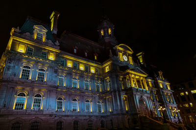 Low angle view of illuminated building at night