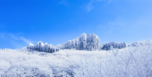 Scenic view of snow covered mountains against sky