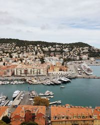 High angle view of townscape by sea against sky