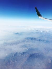 Aerial view of airplane wing over landscape