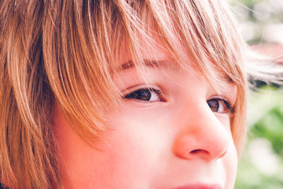 Close-up portrait of cute child sly face expression outdoor sensory connection concept