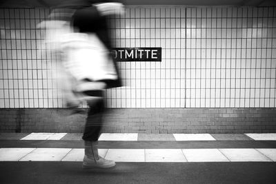Blurred motion of person walking in subway station