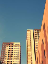 Low angle view of buildings against clear blue sky