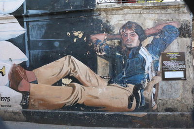 Portrait of young man sitting on floor