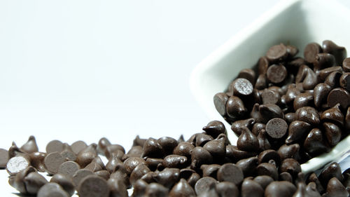 Close-up of coffee beans against white background