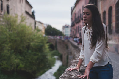 Woman standing by railing