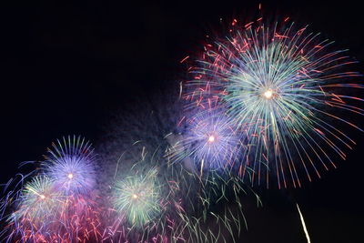 Low angle view of firework display at night