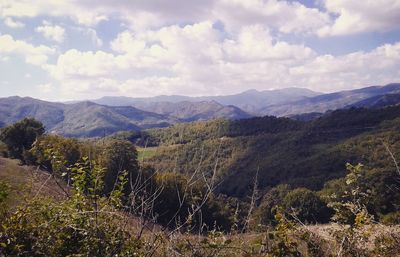 Scenic view of mountains against cloudy sky