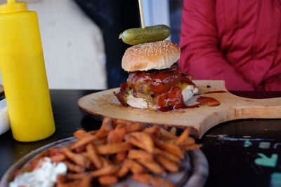 Burger on serving tray at table