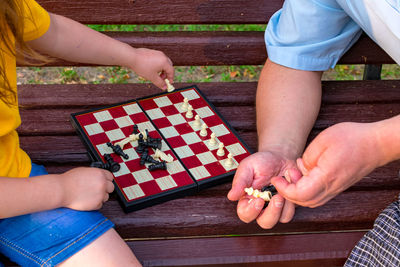 Midsection of man playing jigsaw puzzle at home