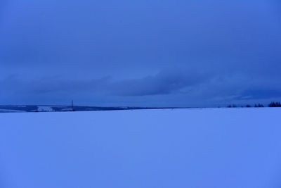 Scenic view of snow against blue sky