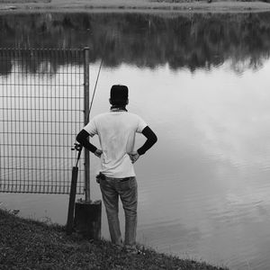 Rear view of man standing in water