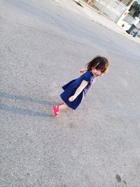 High angle view of girl walking on road