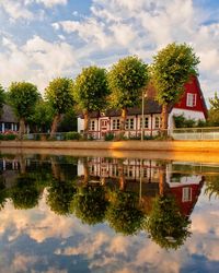 Reflection of trees and buildings in lake