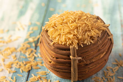 Heap of dry brown rice in a wooden bowl