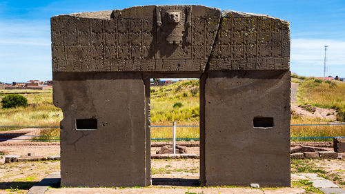 Abandoned built structure on field against sky