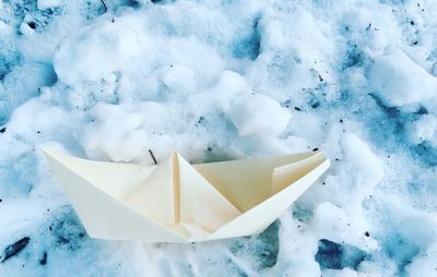 Close-up of paper boat on snow