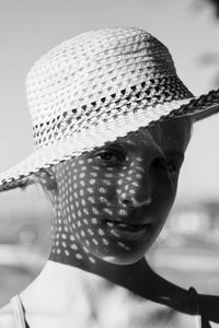 Close-up portrait of girl wearing hat