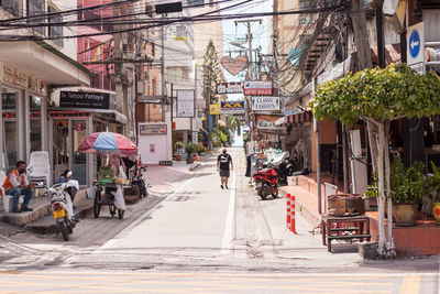 People on city street amidst buildings