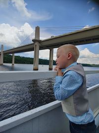 Young boy on boat ride looking over the st. croix river