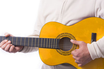 Midsection of man playing guitar