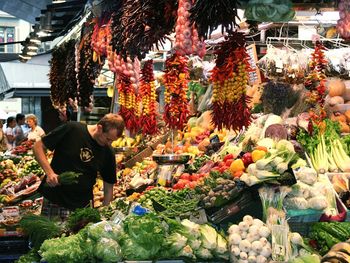 Man choosing vegetables at market stall