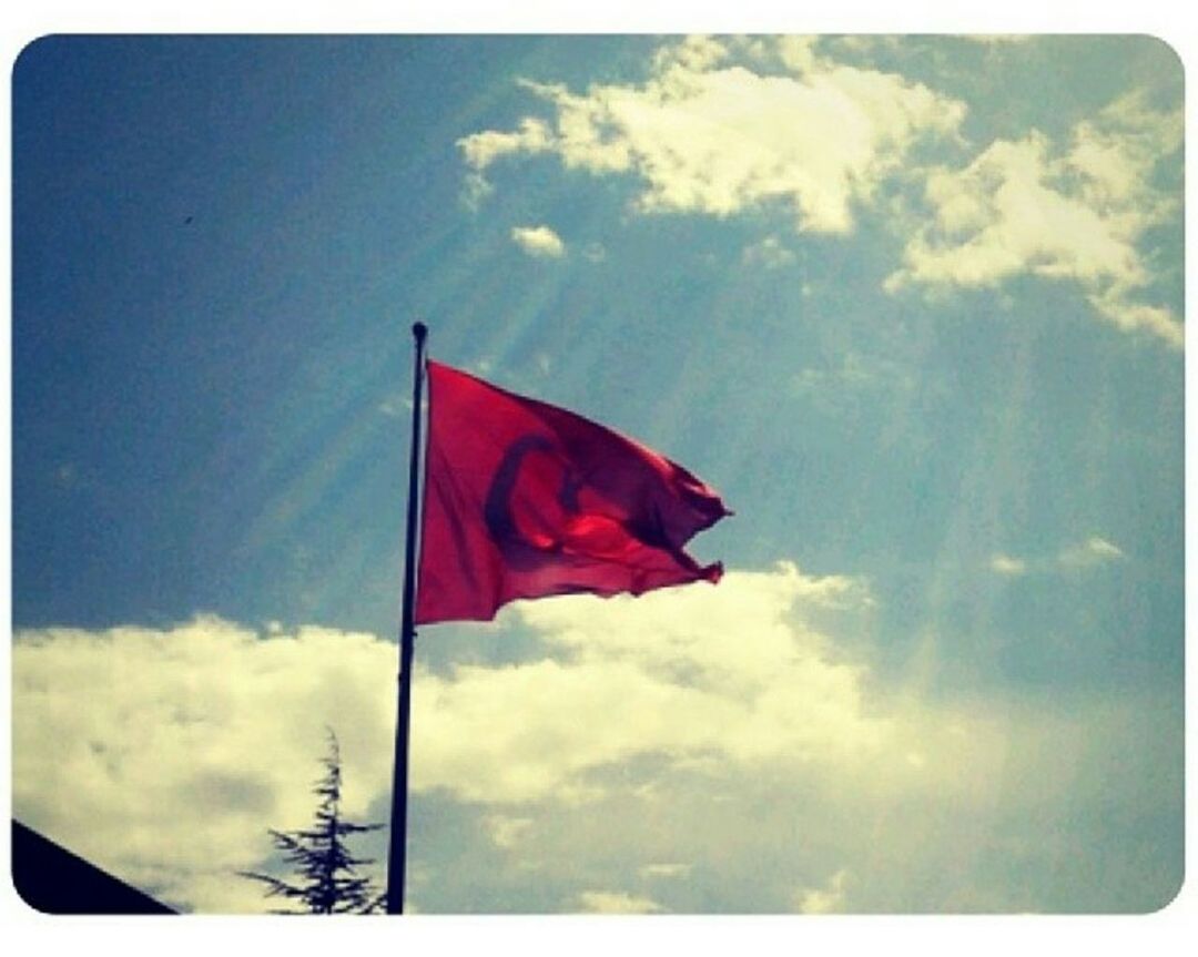 low angle view, flag, sky, patriotism, identity, transfer print, national flag, cloud - sky, red, american flag, cloud, auto post production filter, wind, pole, cloudy, pride, day, culture, blue, outdoors