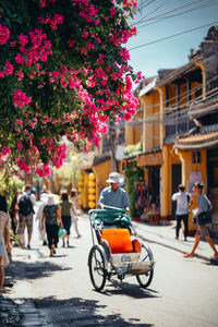 Rear view of people on street amidst buildings