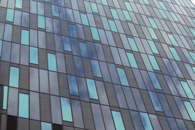 Low angle view of office building against blue sky