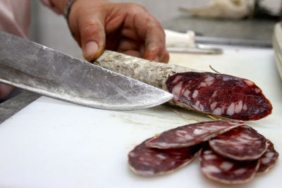 Close-up of person preparing food on cutting board