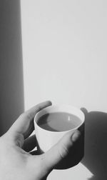 Close-up of hand holding tea cup