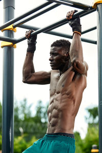 Low angle view of man exercising in gym