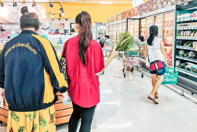 Rear view of women standing at store