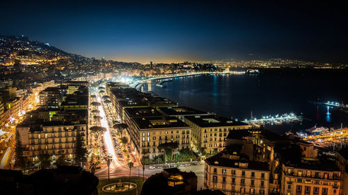 Illuminated cityscape against sky at night