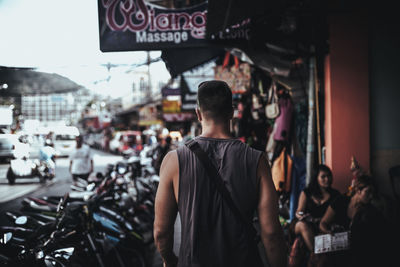 People walking by parked motorbikes